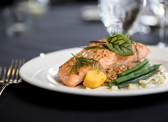 Plate of salmon fillet on linen table