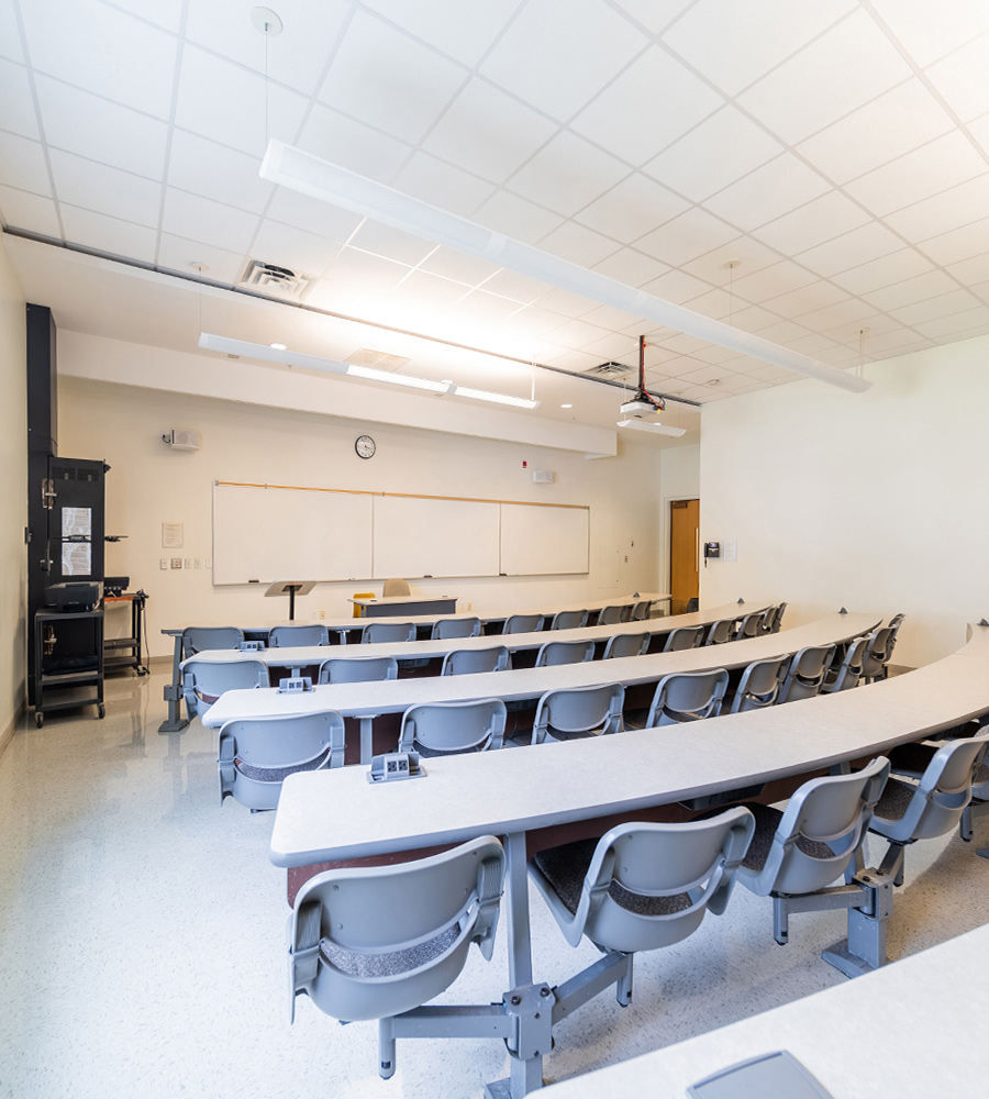 Lecture style classroom with fixed tables and chairs