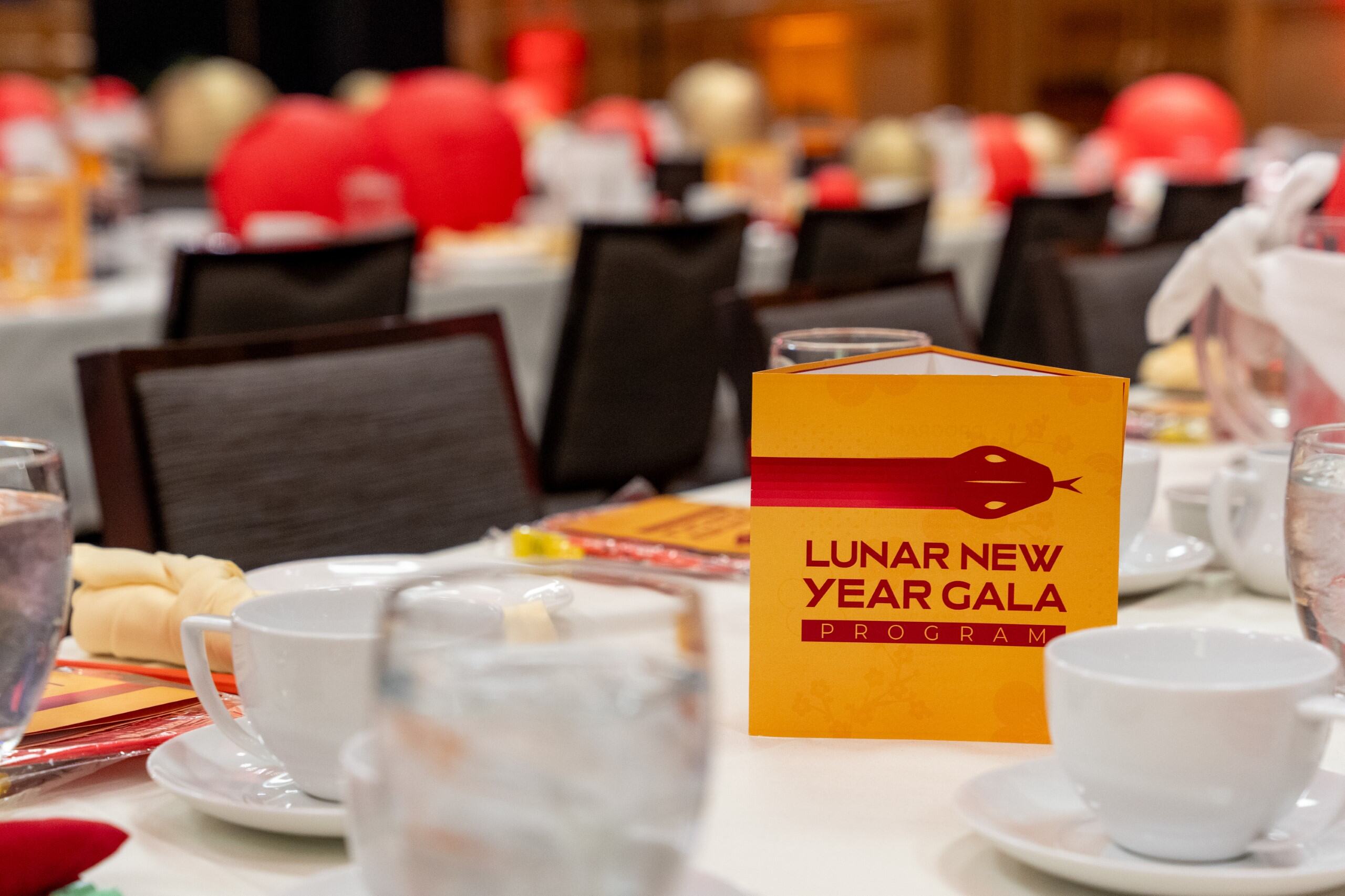 A set table with a Lunar New Year Gala program sign